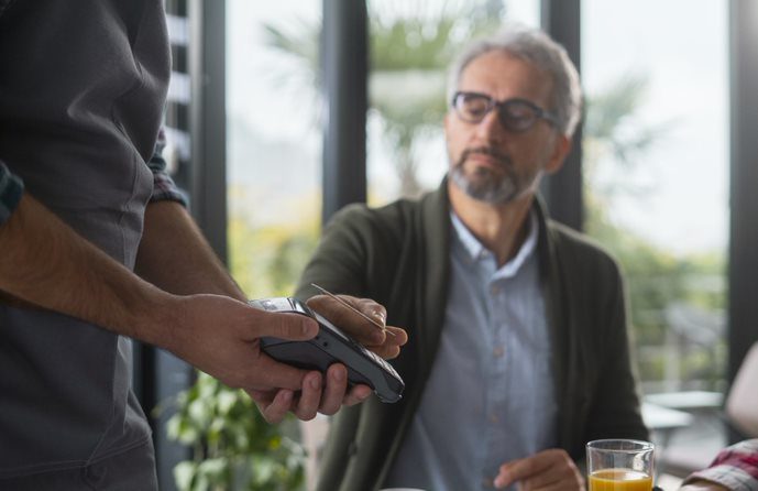 man paying by card