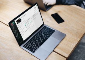 Macbook Pro Space Gray mockup on the wooden table EN-GB