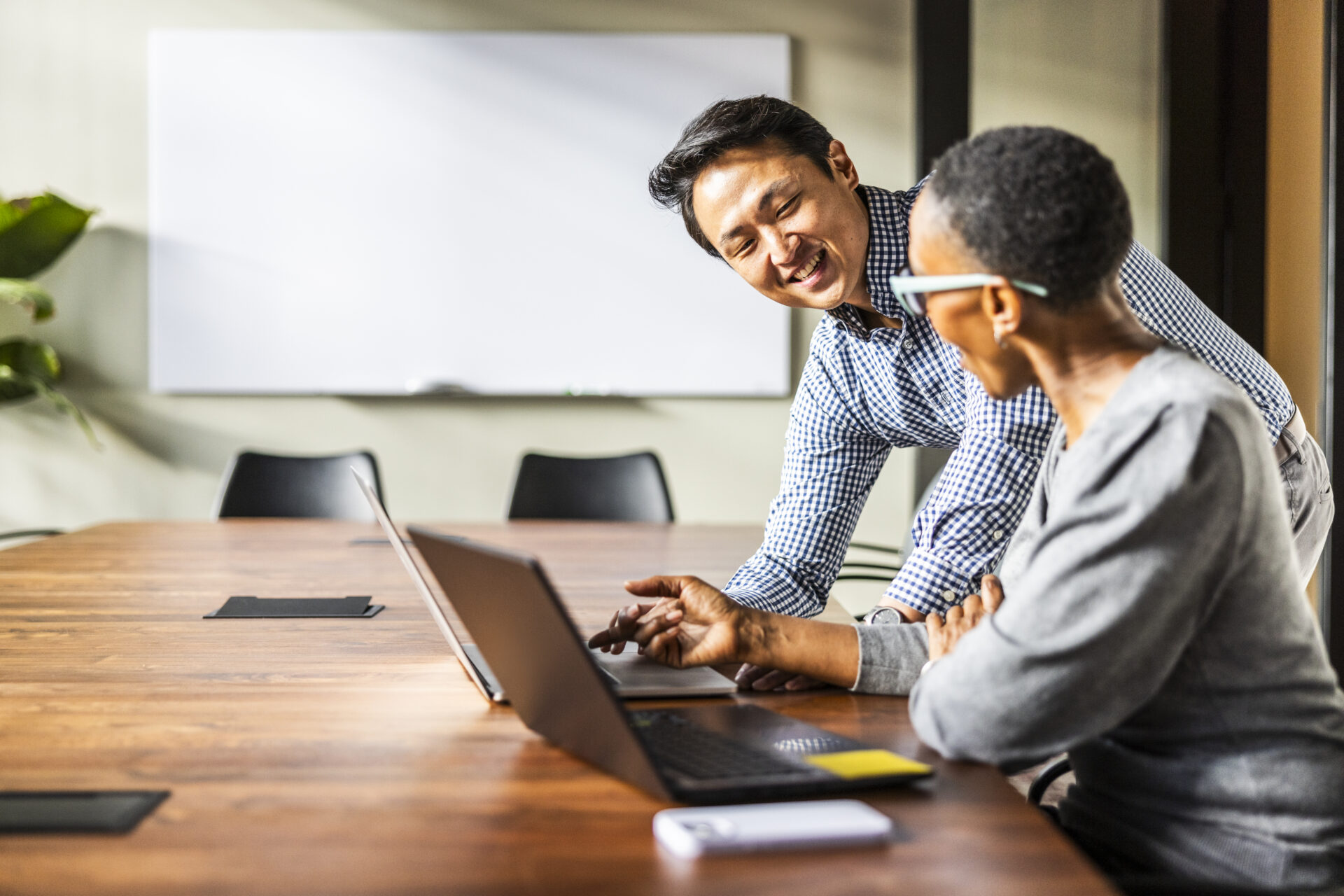 CFO leading a boardroom strategy session using real-time financial dashboards.