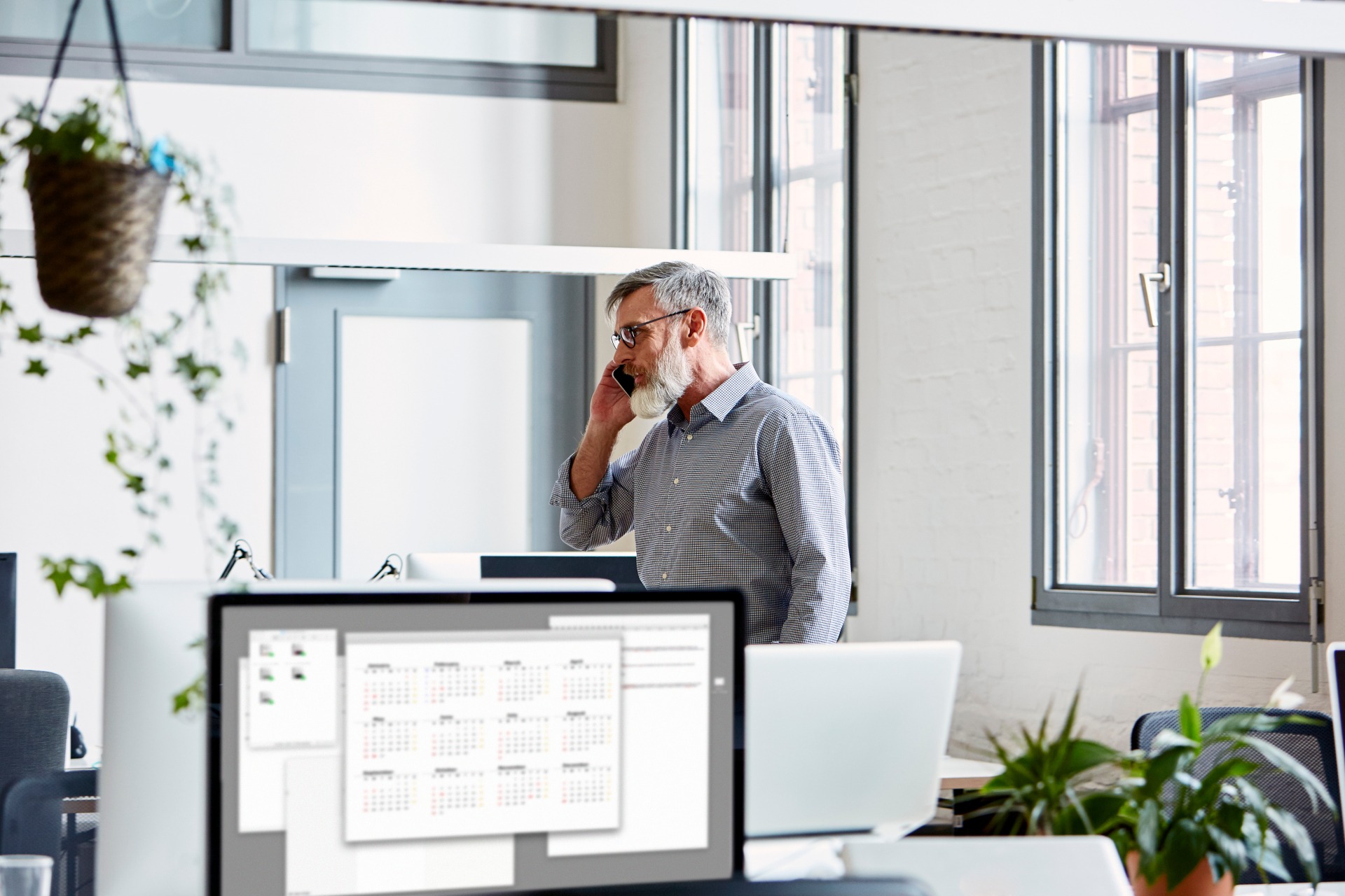 Businessman Talking On Mobile Phone In Creative Office